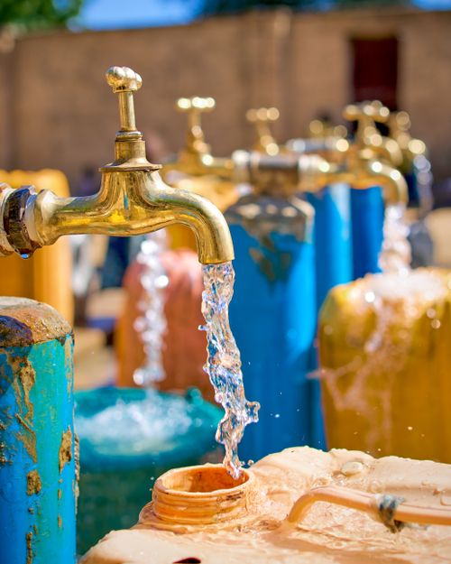 Free Outdoor array of colorful water taps with flowing streams in daylight. Stock Photo