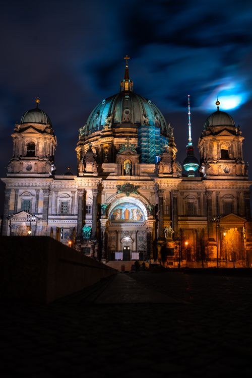 Free Stunning night view of the Berlin Cathedral with dramatic lighting and moody clouds. Stock Photo