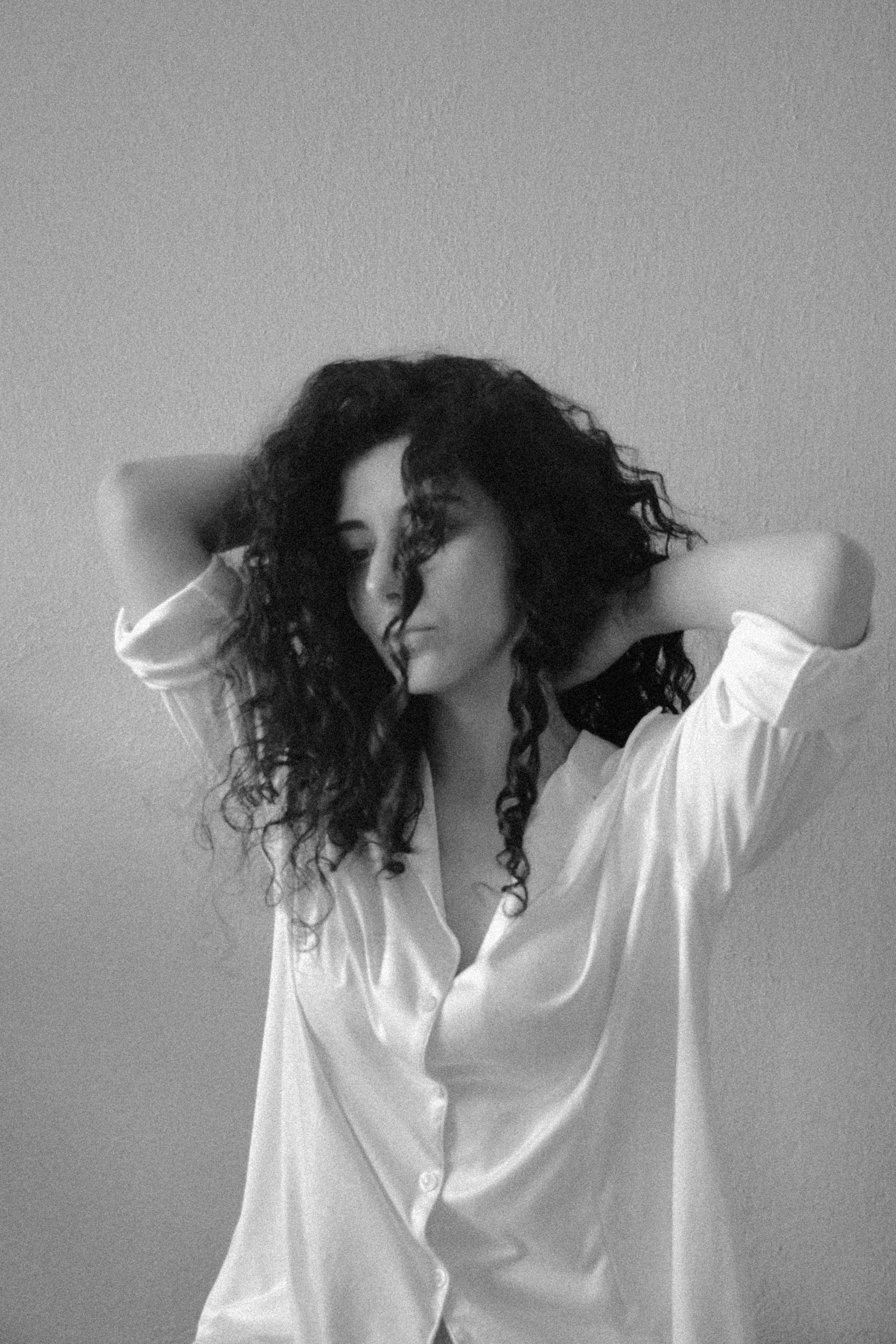 Black and White Portrait of a Woman with Curly Hair · Free Stock Photo