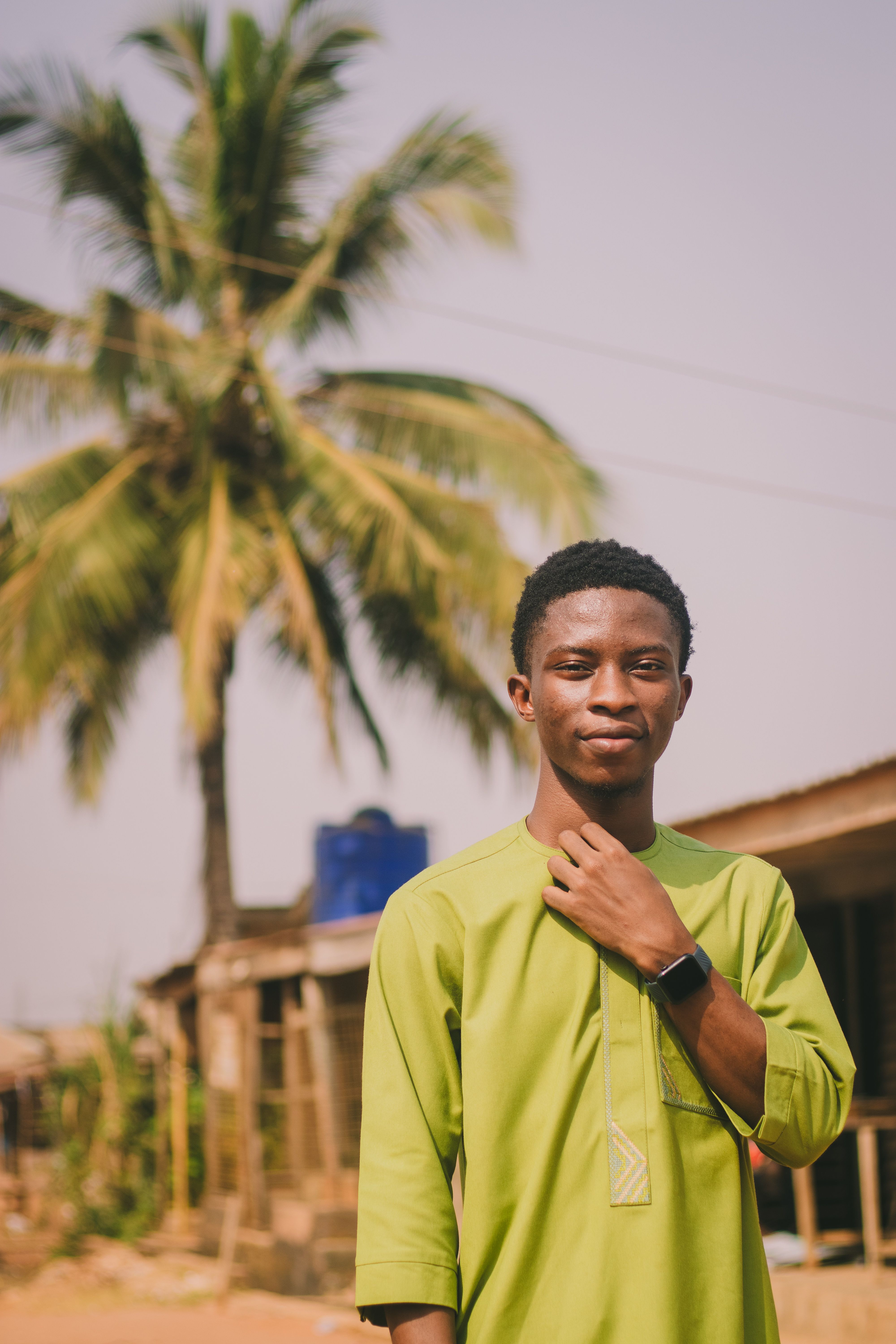 Young Man in Green Traditional Attire Outdoors · Free Stock Photo