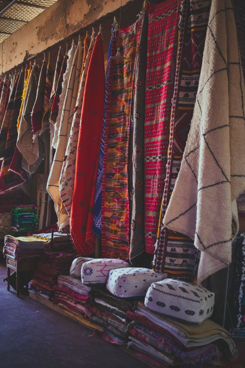 Free Brightly colored Moroccan rugs on display in Agadir market, showcasing traditional textile art. Stock Photo