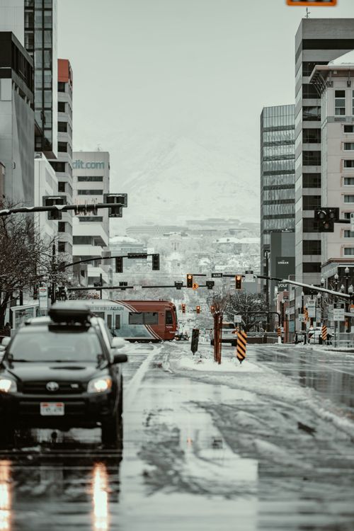 Free Snow-covered streets of downtown Salt Lake City with traffic and tall buildings on a winter day. Stock Photo