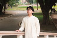 Young man in traditional attire at park outdoors