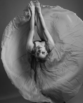 Elegant ballet dancer with arms extended, captured in a dynamic pose and flowing dress.