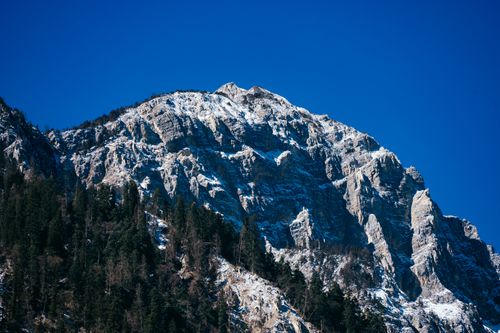 Free Stunning view of a snow-capped mountain peak with clear blue skies, perfect for nature lovers. Stock Photo