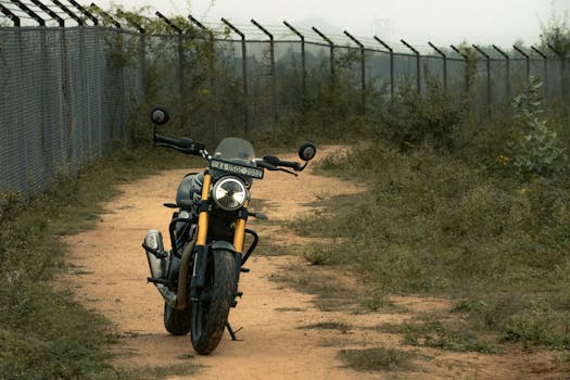 A sleek motorcycle navigates a secluded dirt path in Bengaluru, India, capturing the spirit of adventure.