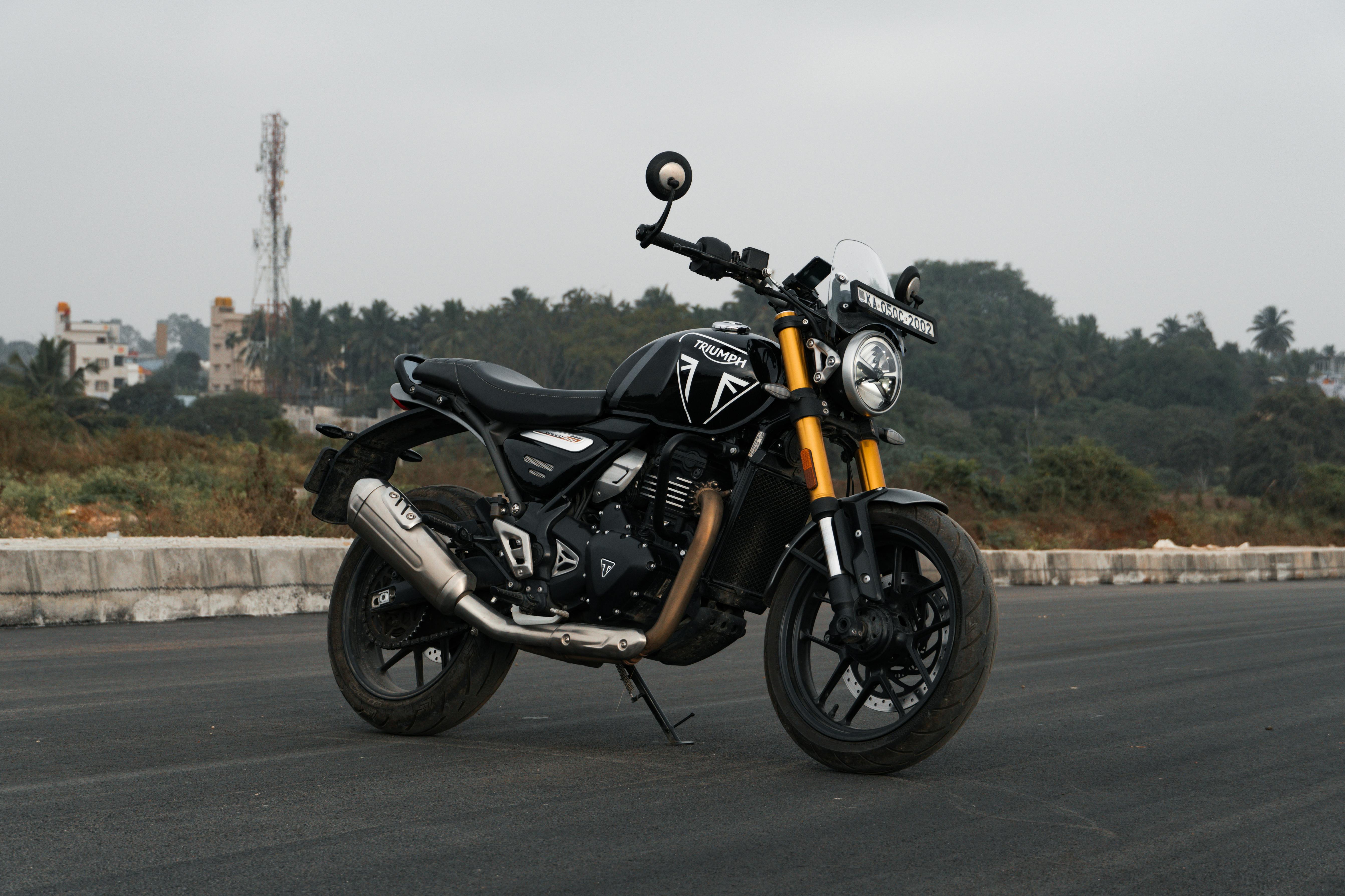 A Triumph motorcycle parked on an open road in Bengaluru, India.