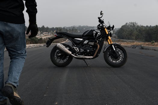 Black motorcycle parked on an empty road in Bengaluru, India.