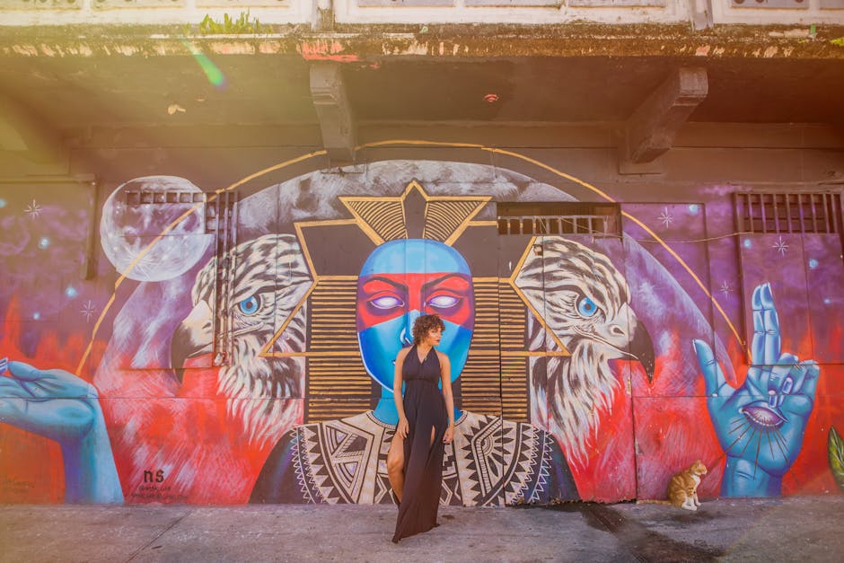 A model wearing a dress made from recycled plastic bottles, posing in front of a colorful mural.