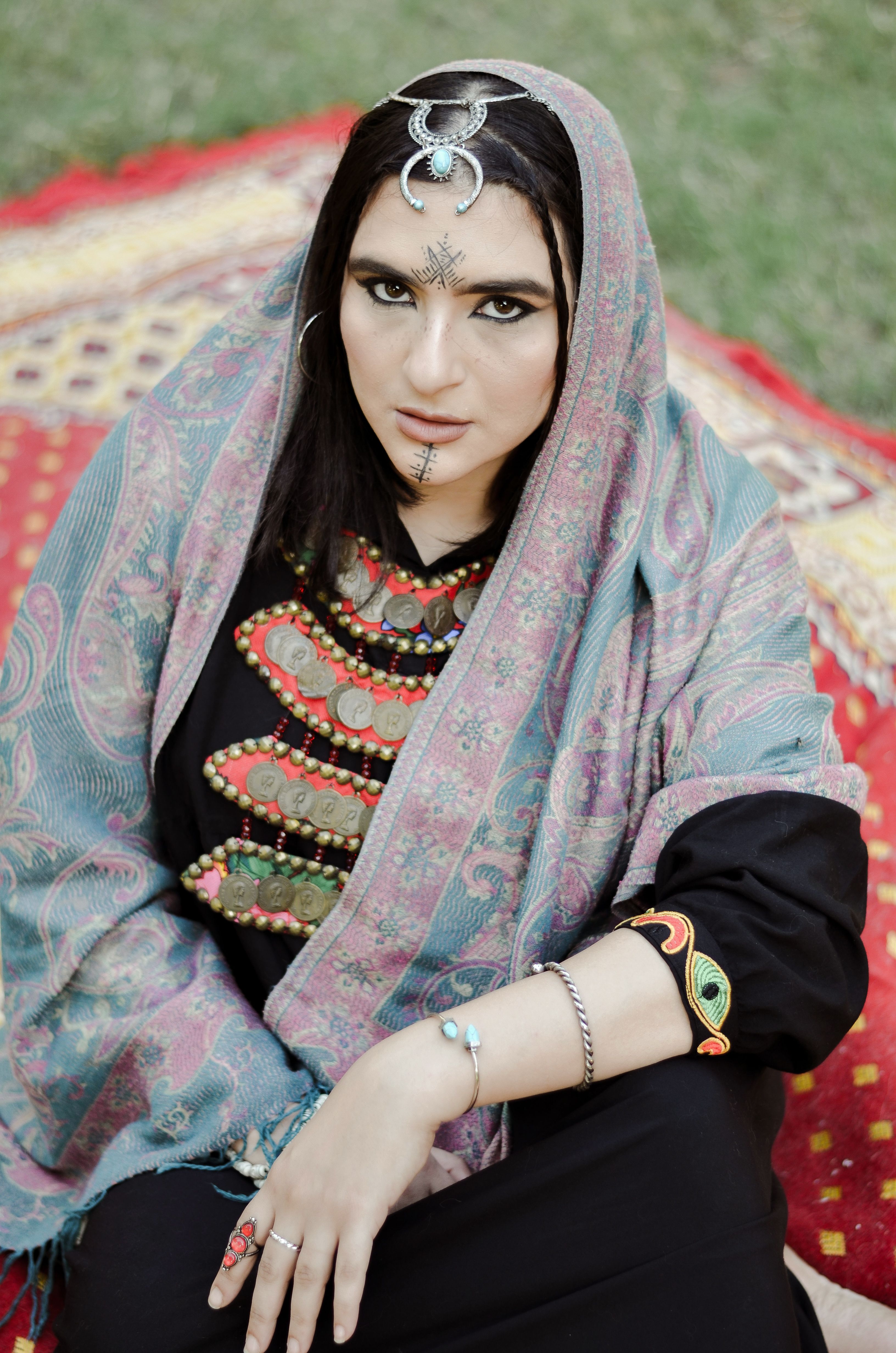 Woman wearing traditional Egyptian attire with tribal jewelry outdoors in Cairo.