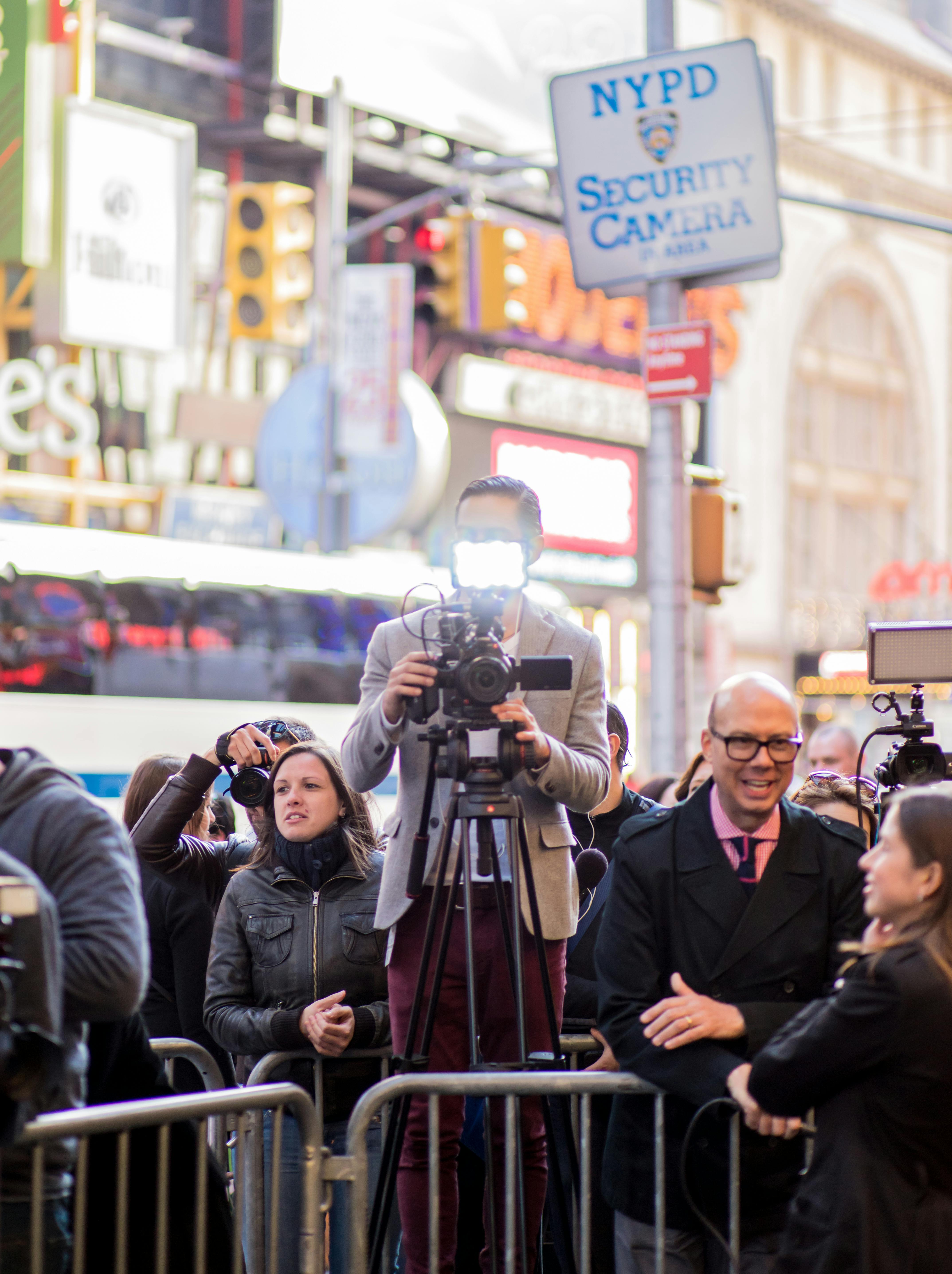 journalists standing behind barrier