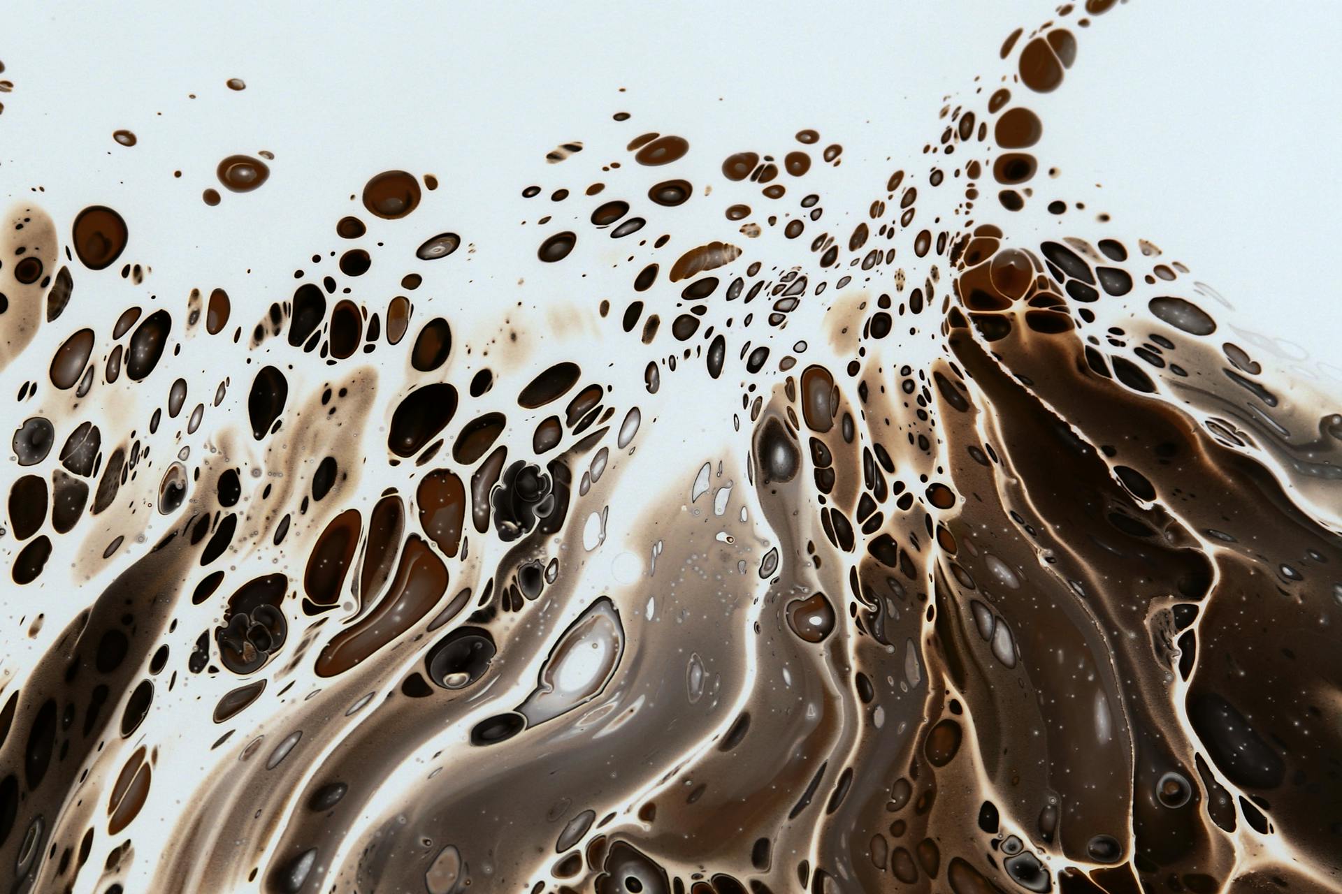 Captivating abstract art featuring dynamic brown and white liquid swirl patterns.