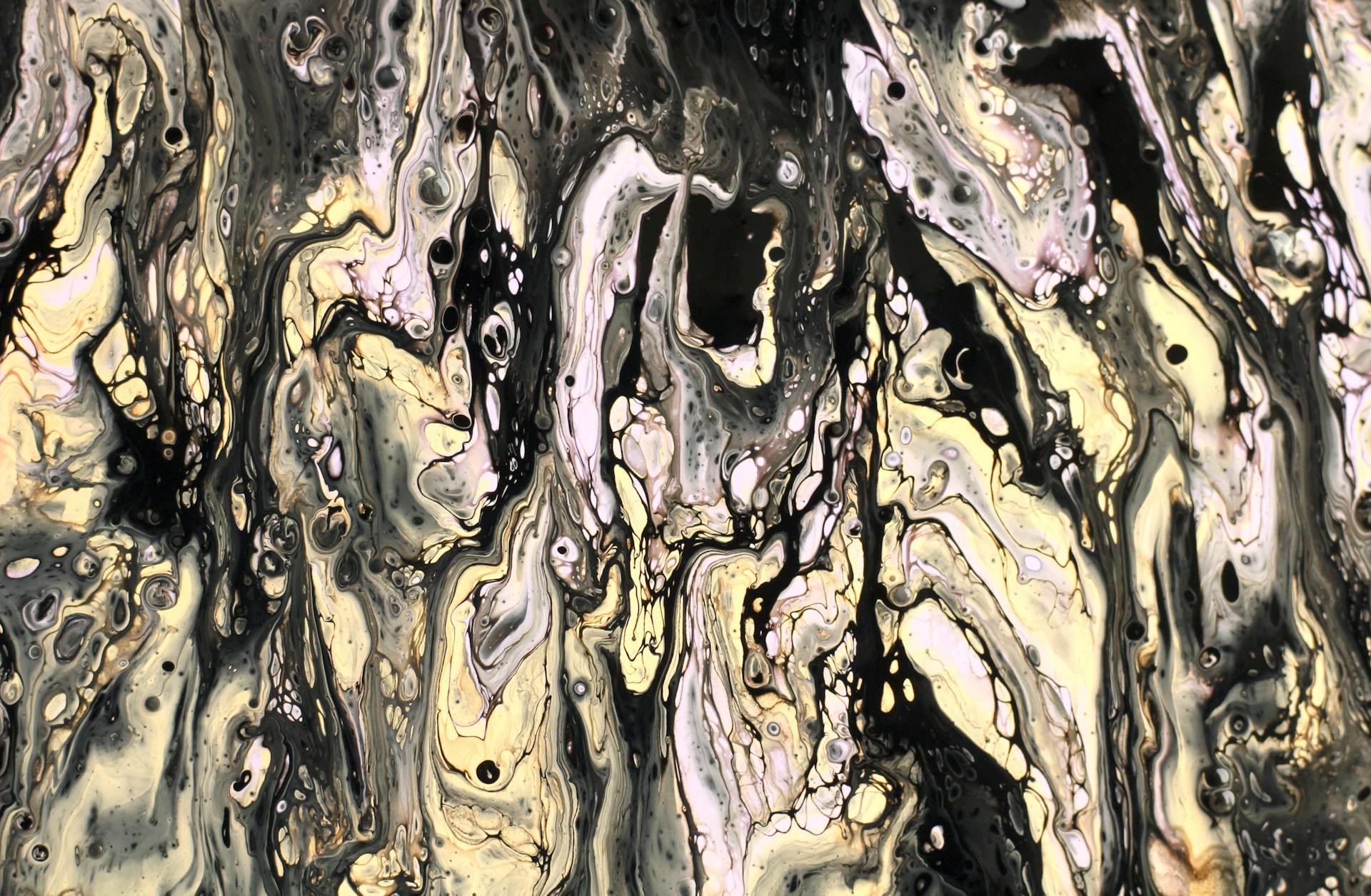 Dynamic abstract fluid art in black, white, and gold with swirling patterns and textures.