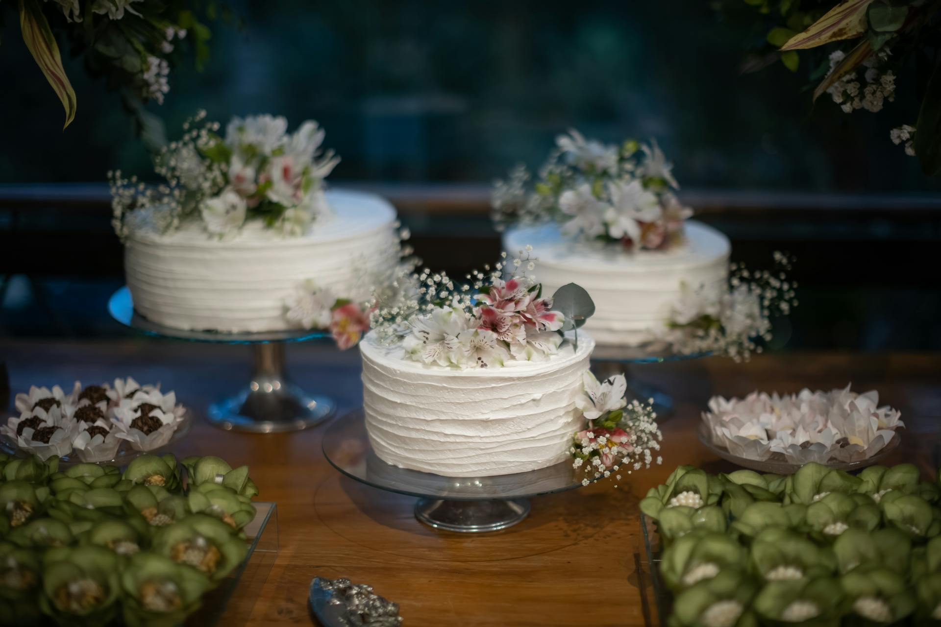 Delicate white cakes with floral decorations, perfect for weddings or special occasions.