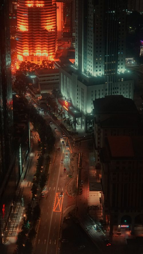 Free Vibrant aerial view of Kuala Lumpur cityscape at night, showcasing illuminated skyscrapers. Stock Photo