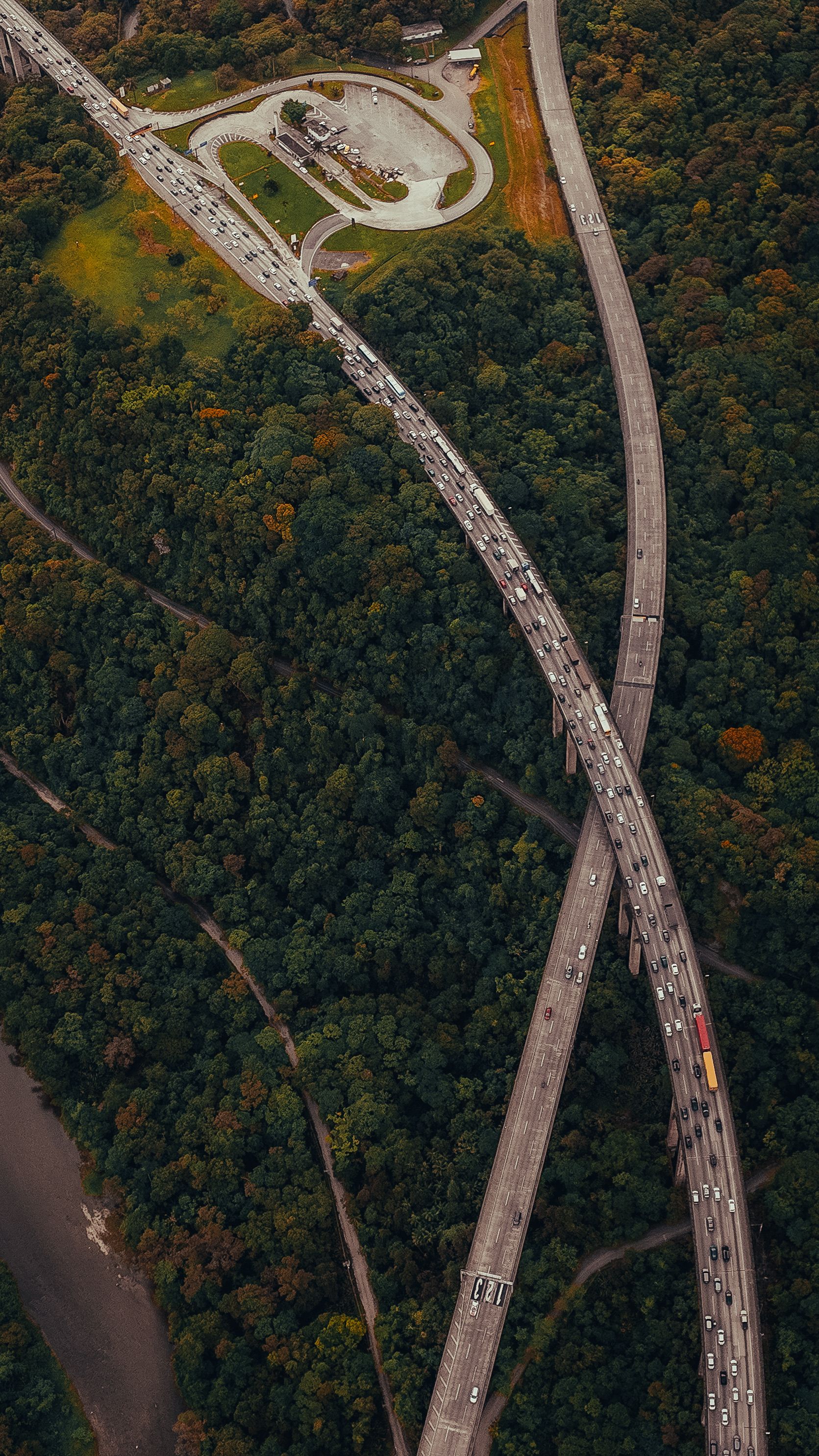 Aerial View of Highway Intersection Through Forest · Free Stock Photo