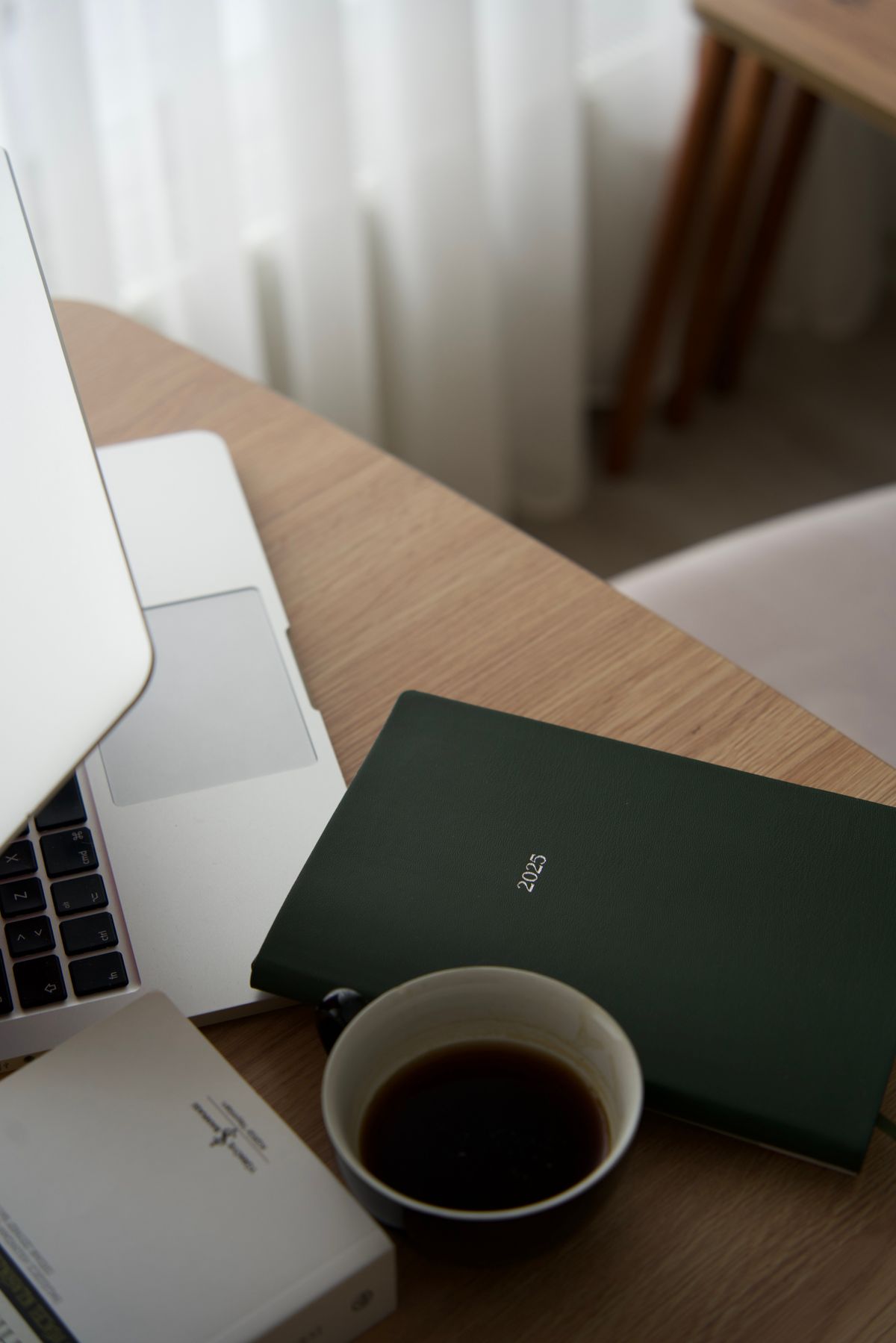 A tidy desk prepared the night before, with a notebook and pen laid out ready to start.