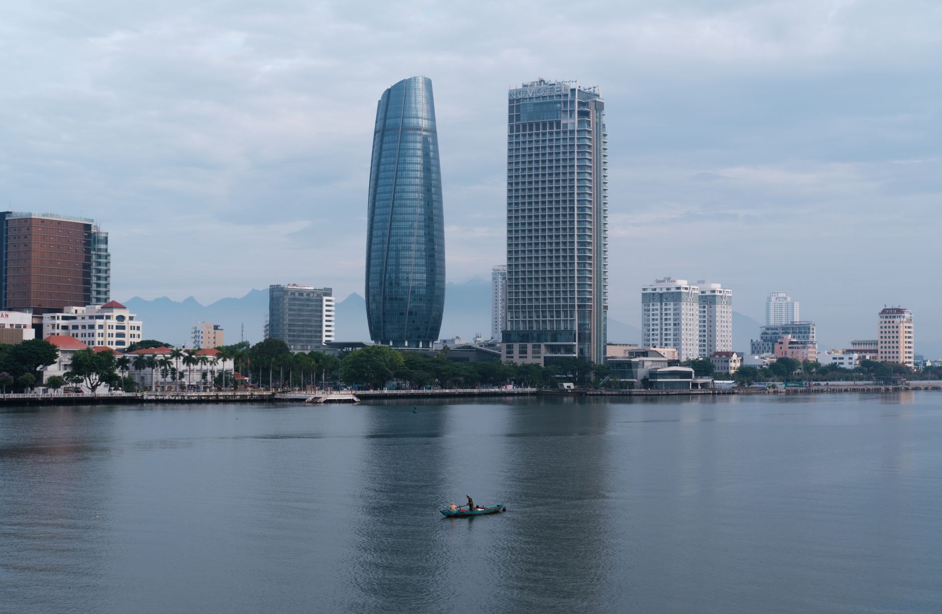 Stunning view of Da Nang skyline with Han River reflecting modern architecture, Vietnam.