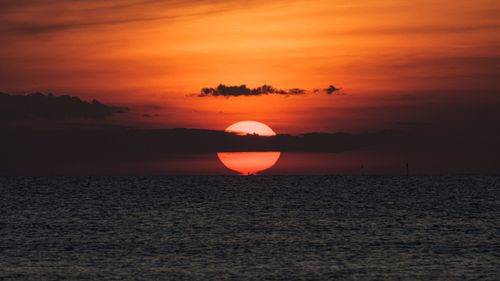 Free Beautiful sunset over the ocean in Da Nang, Vietnam, with vivid red and orange hues. Stock Photo