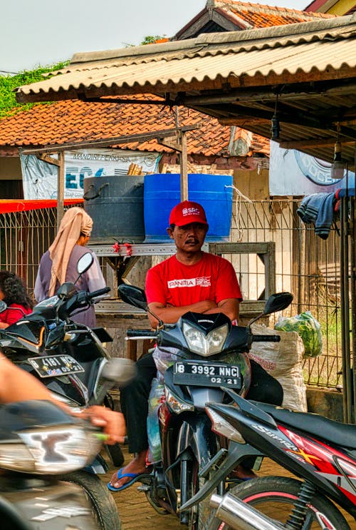 Man Wearing Red Shirt Riding A Motorcycle