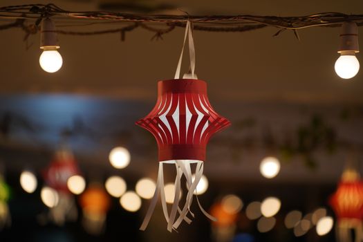 Red paper lantern with warm lights, perfect for festive celebrations or seasonal decorations.