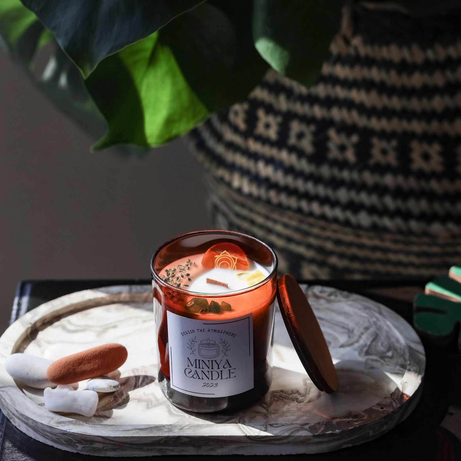 A soy wax candle with a wooden lid.