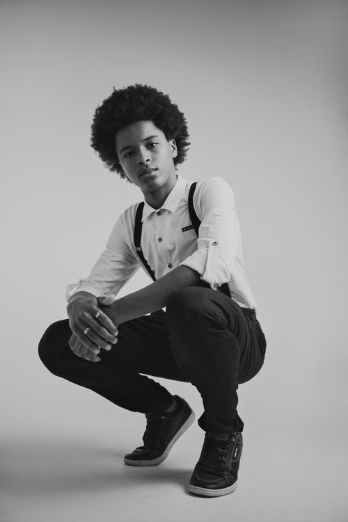 Free Monochrome portrait featuring a young man in suspenders, exuding confidence. Stock Photo