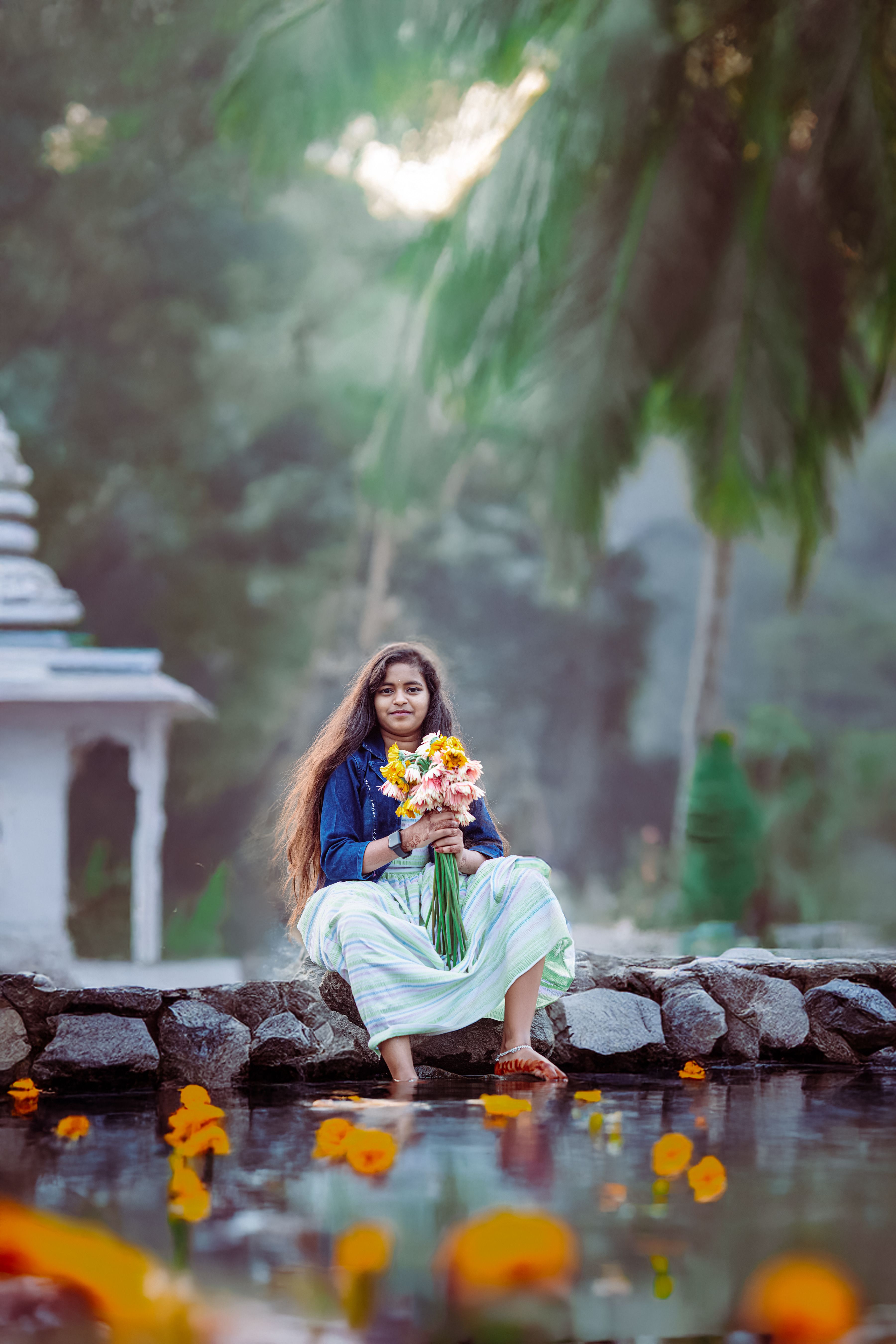 Young Woman with Bouquet by Reflective Pond · Free Stock Photo