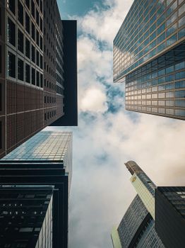 Capture of towering skyscrapers in Frankfurt, Germany against a cloudy sky.