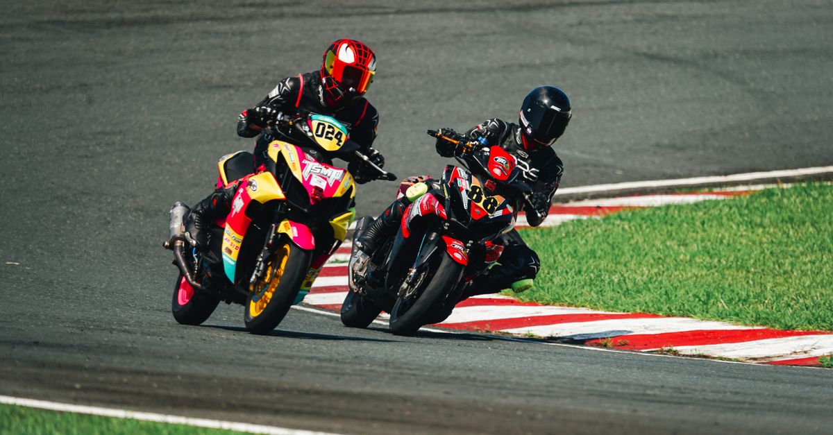 Two motorcyclists racing on a track in Rosario, Calabarzon, Philippines.