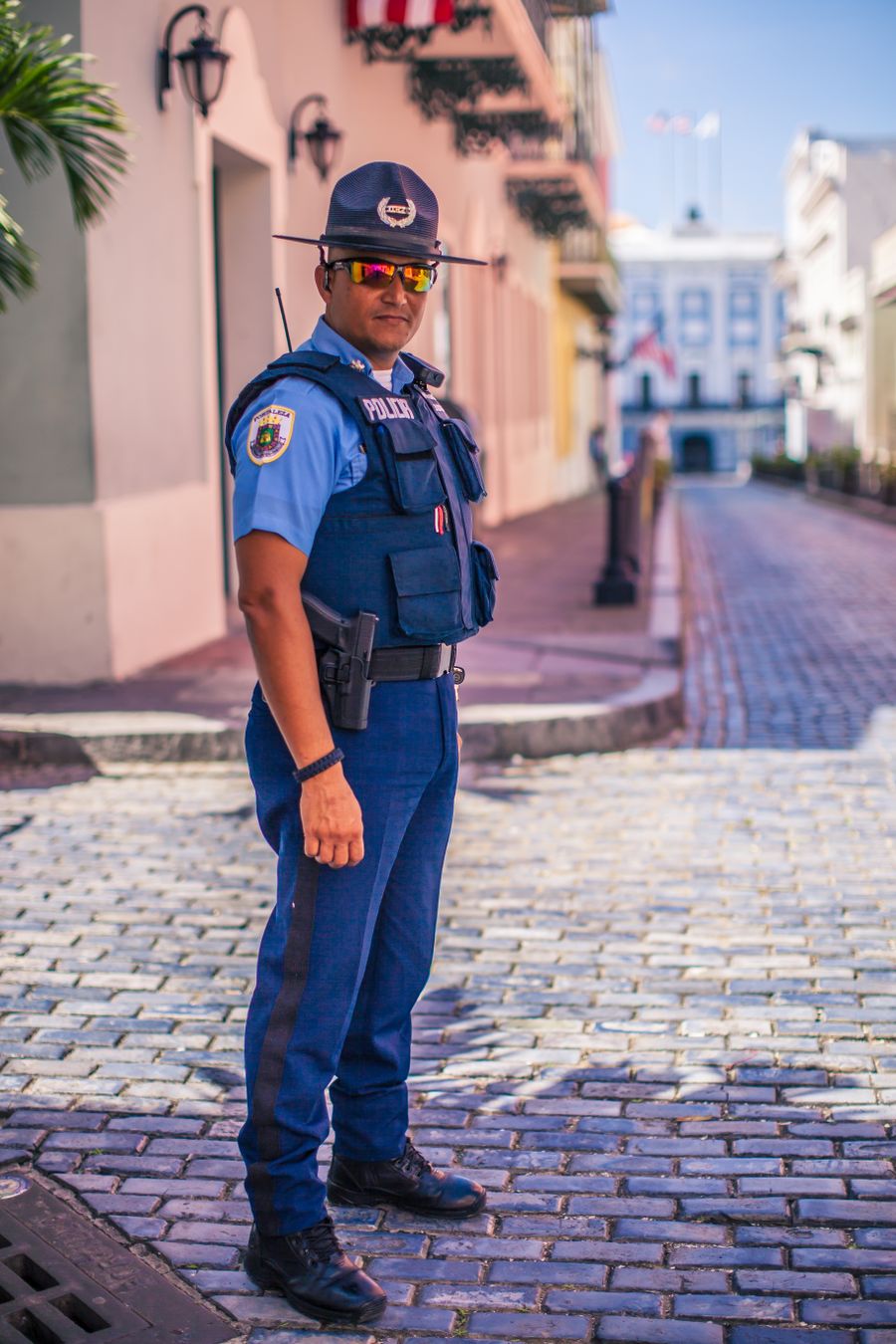 Police officer in uniform standing on city street