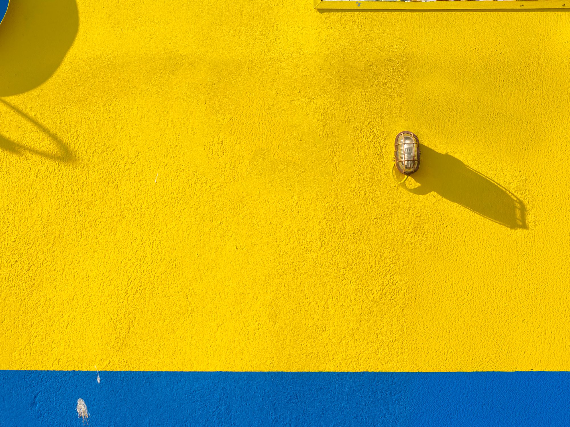 Painters & Decorators in Fitzrovia, London — professional decorator painting a wall with a roller