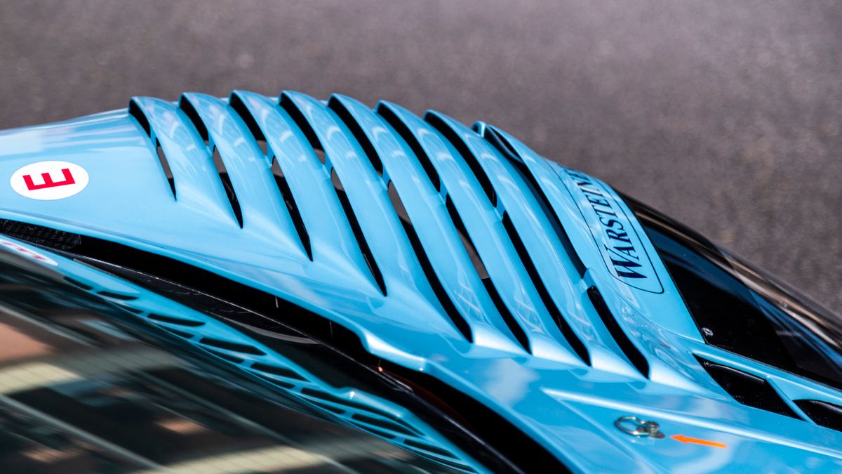 Close-up of a car air vent, the kind of vent where clip-on air fresheners attach