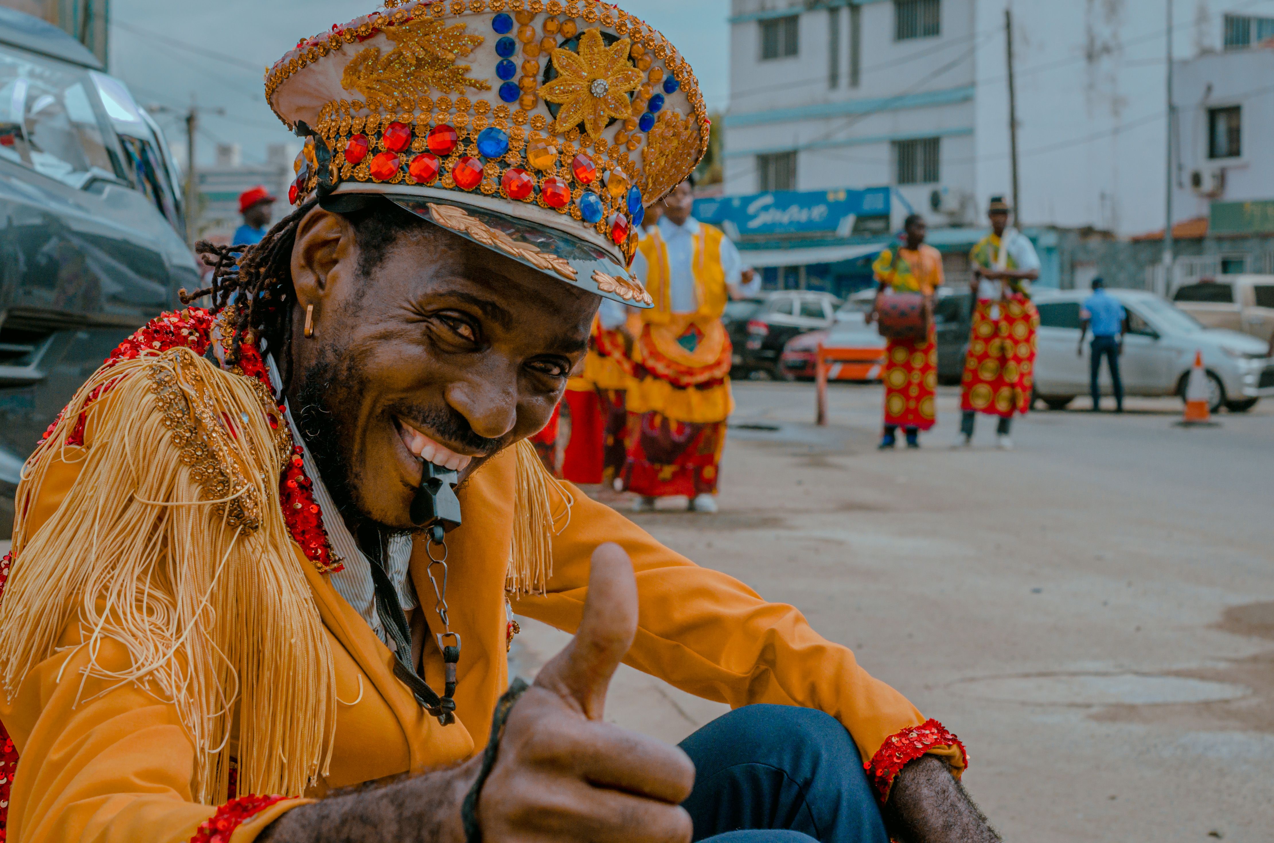Colorful street carnival featuring traditional attire and dance in Luanda, Angola.