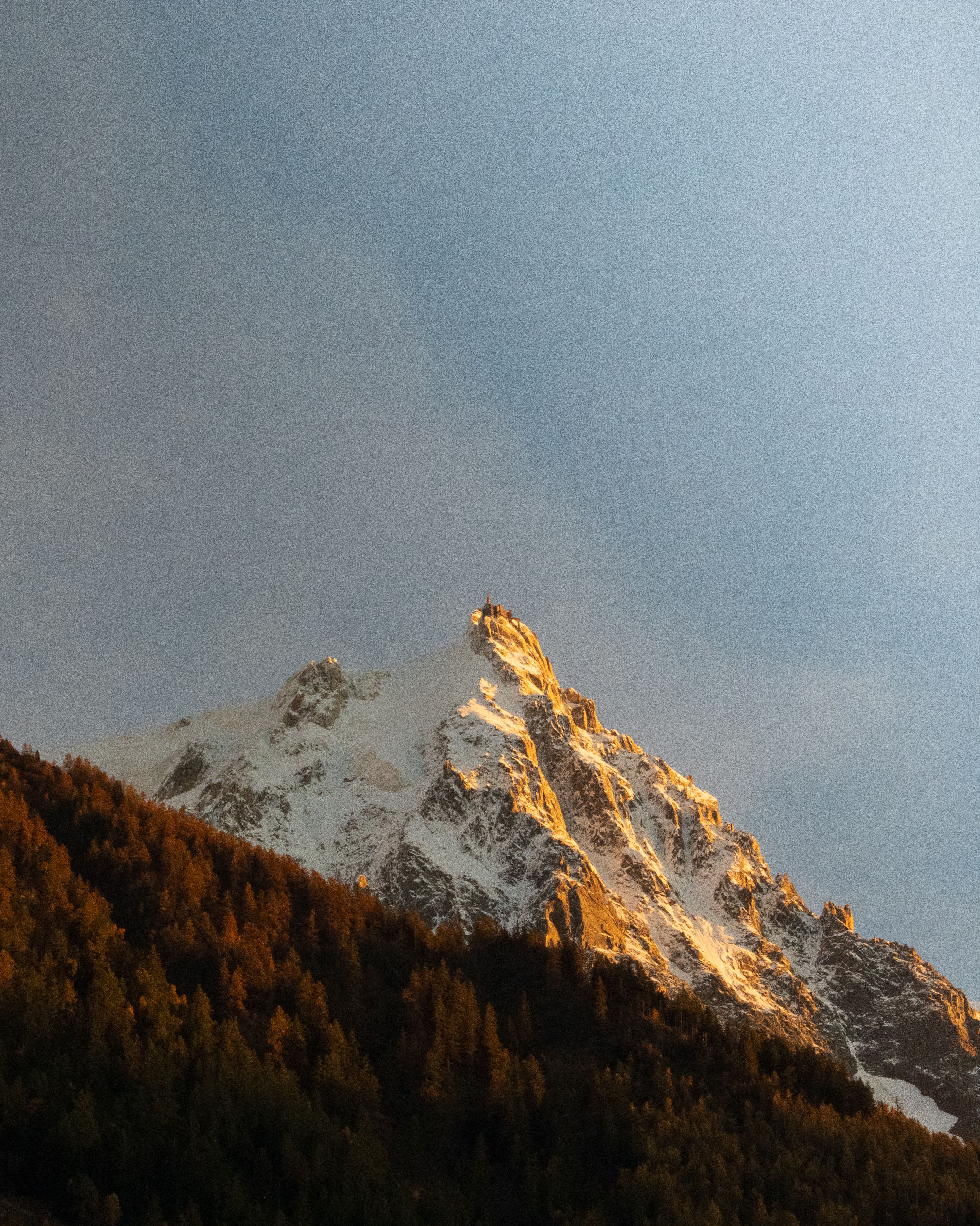 Breathtaking view of a sunlit mountain peak during golden hour in Chamonix-Mont-Blanc.