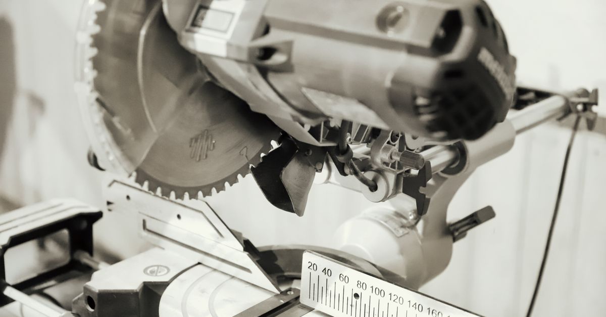 Close-up of a professional chop saw with measurement scale, ideal for woodworking tasks.