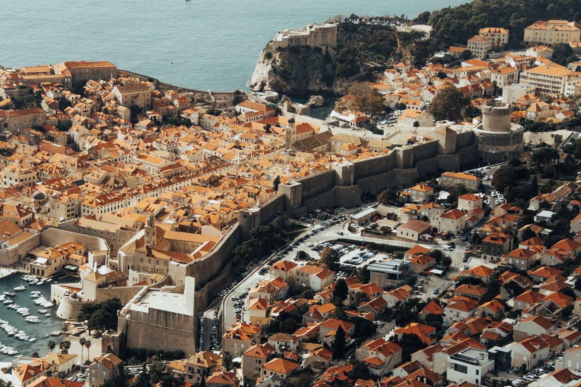 Explore the stunning aerial view of Dubrovnik's fortified Old Town and its Mediterranean architecture.