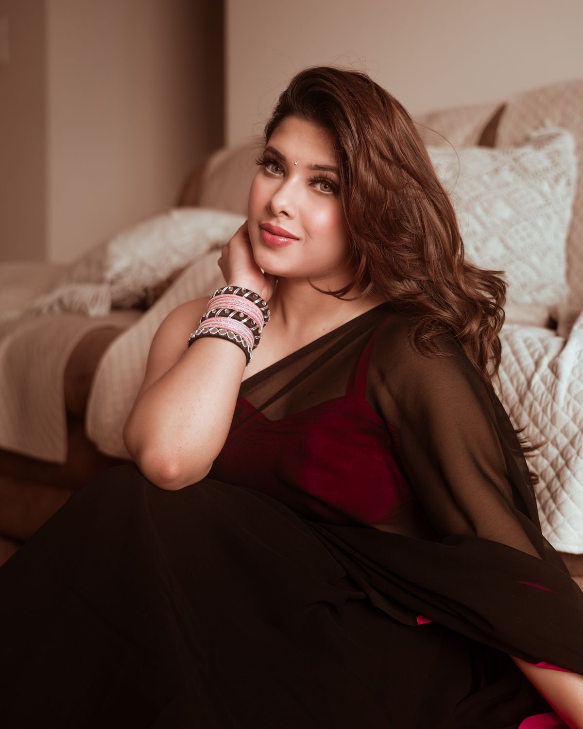 Elegant Woman in Traditional Attire Relaxing Indoors · Free Stock Photo