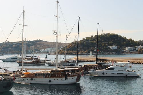 Free Elegant boats anchored in Bodrum harbor under a sunny sky, showcasing serene coastal beauty. Stock Photo