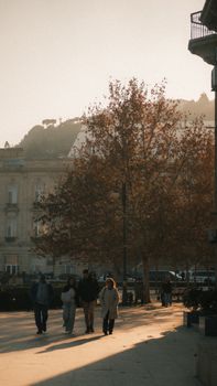 Scenic view of people walking on a sunny day in Baku, Azerbaijan, with autumn trees and architecture.