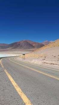 Winding road through the stunning desert landscape of the Chilean Altiplano.
