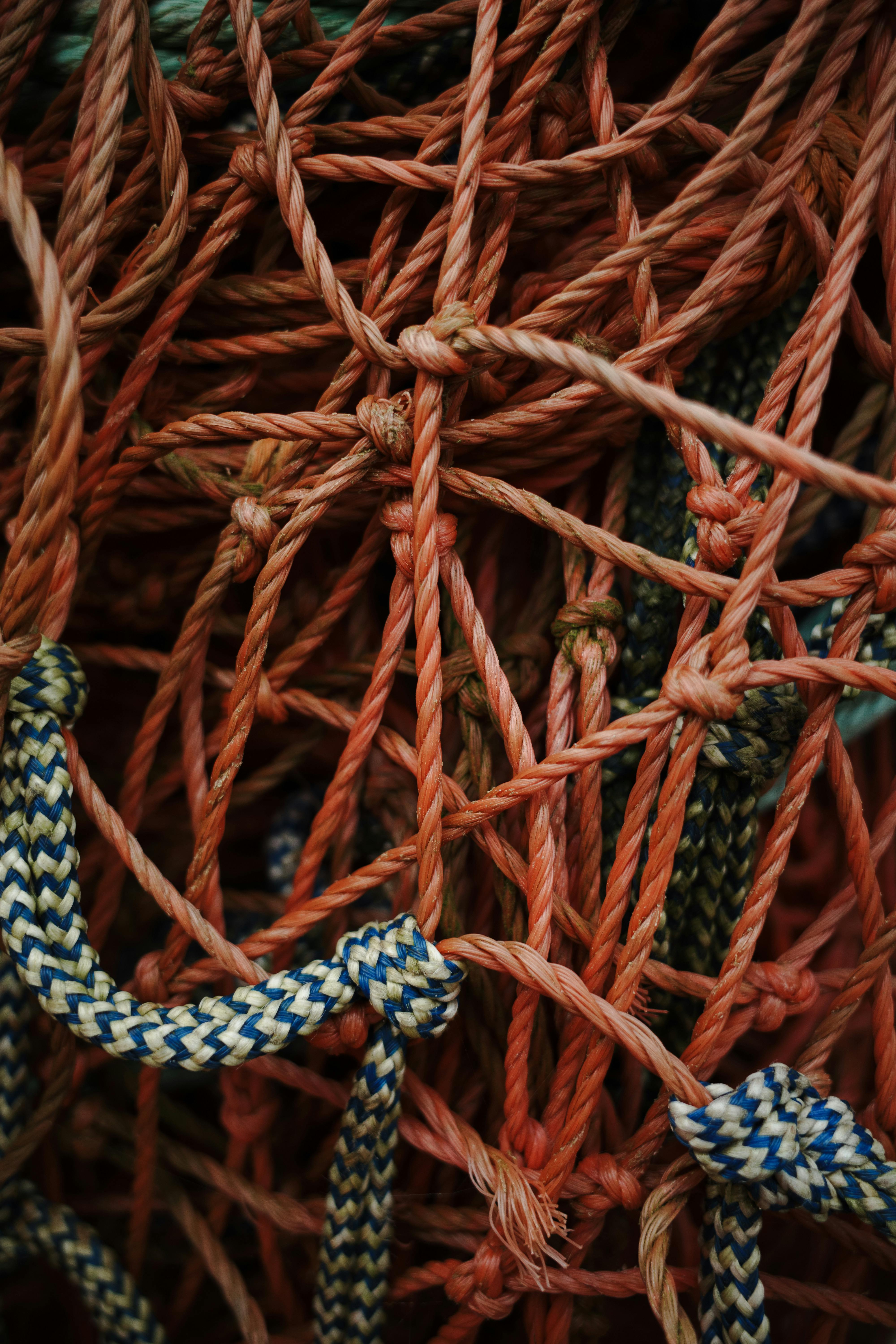 Intricate tangle of vibrant fishing nets and ropes in close-up view.