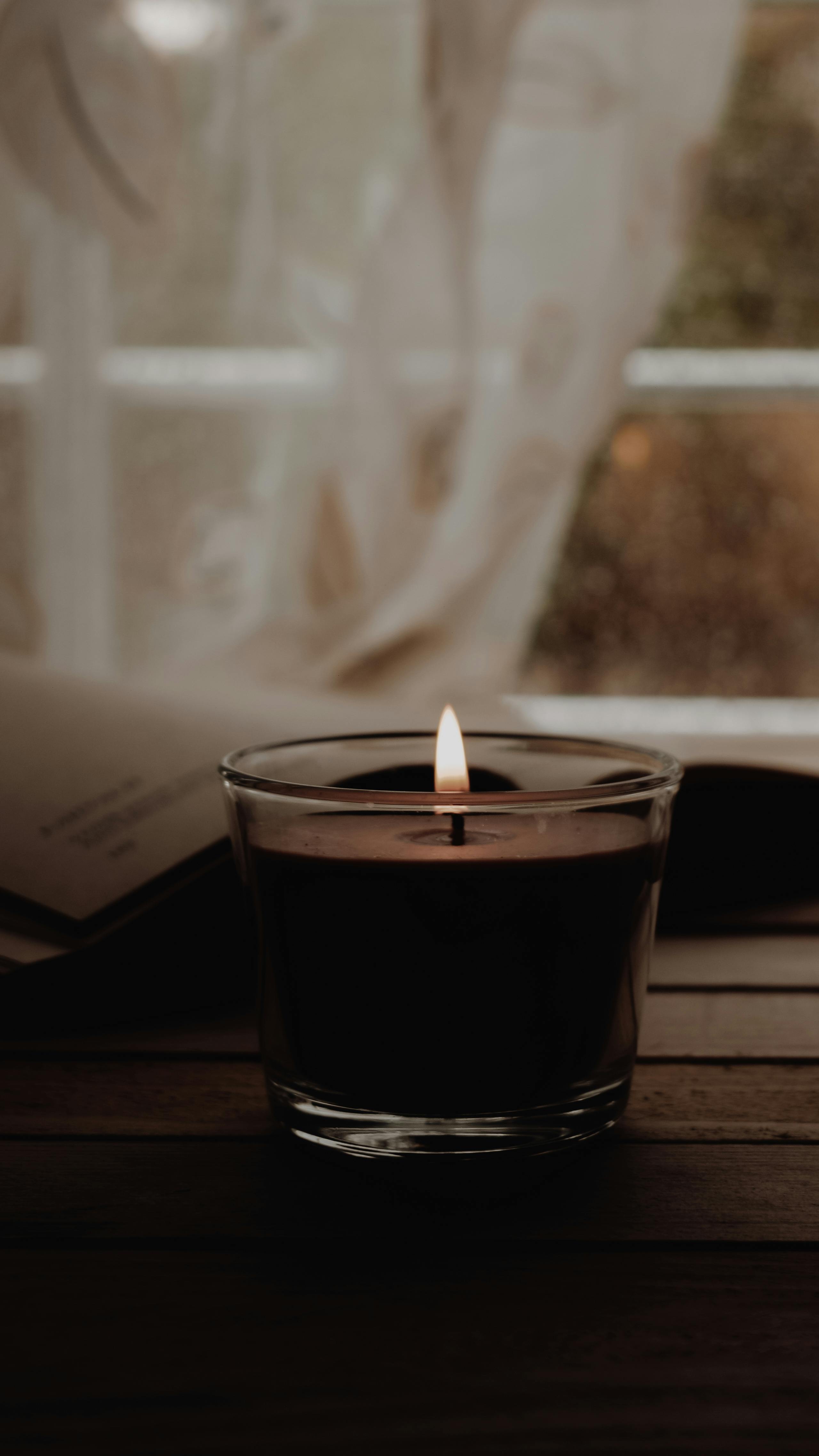 A warm candlelit scene with a softly focused background, perfect for relaxation and meditation.