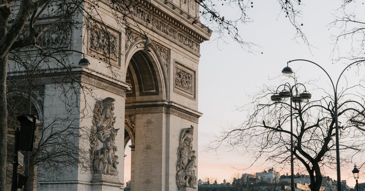 Capture of Arc de Triomphe at twilight with cars passing by in Paris. Capture of Arc de Triomphe at twilight with cars passing by in Paris.
