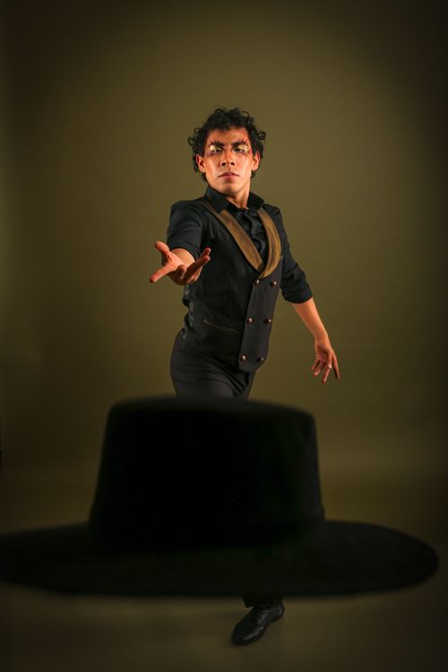 Free Flamenco dancer in dynamic pose with hat in foreground. Stock Photo