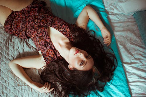 Free High-Angle Photo of Woman Lying Down on Bed Stock Photo