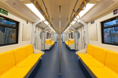 An empty metro carriage with yellow seats