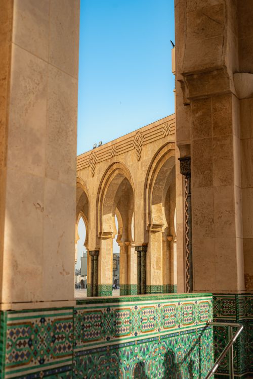 Free Capture of intricate Moroccan arches with blue sky background. Stock Photo