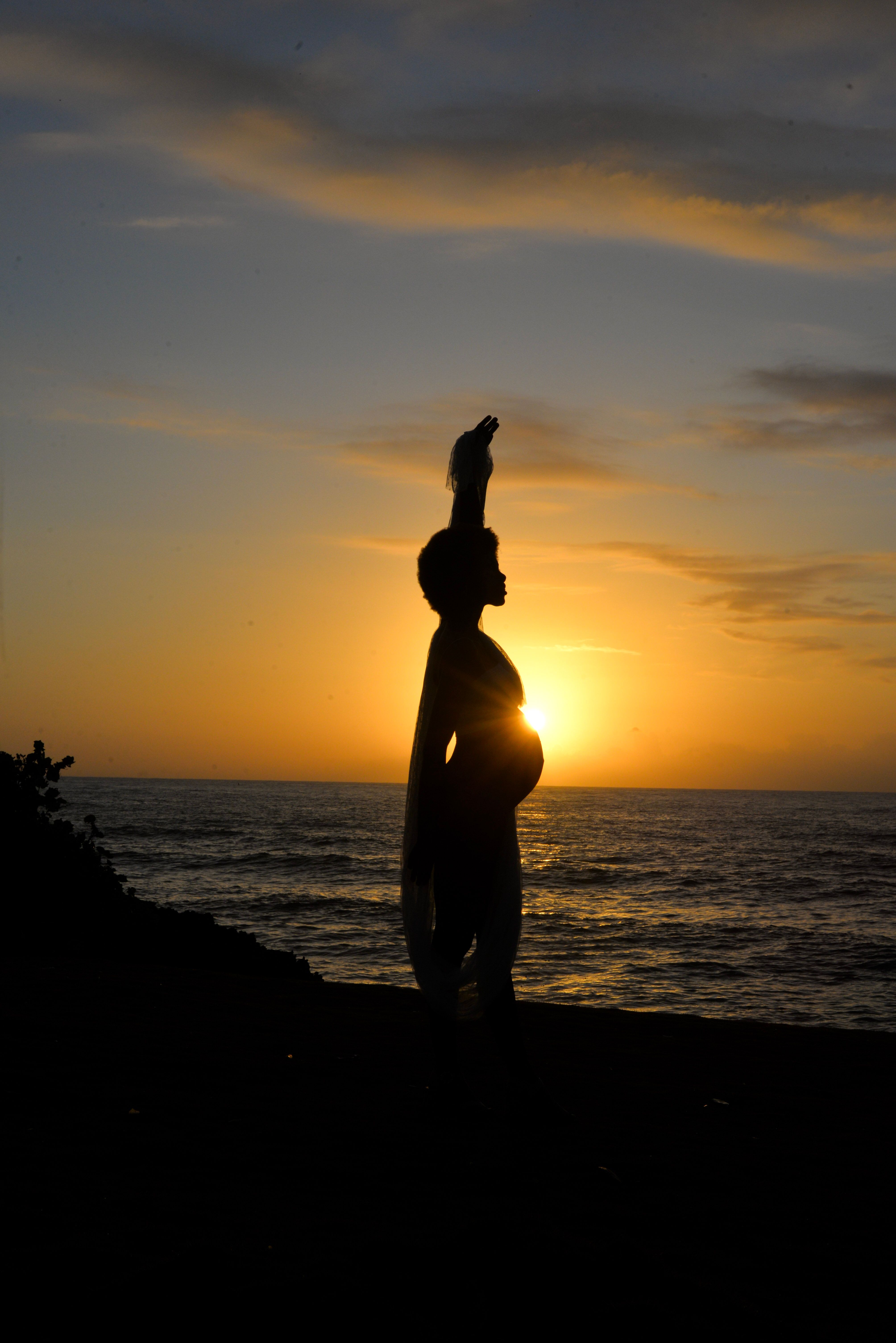 Silhouette of Pregnant Woman at Sunset Beach · Free Stock Photo