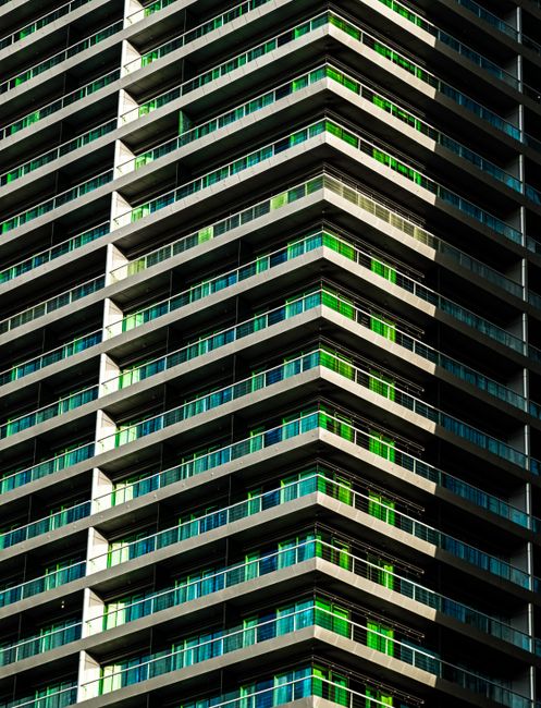 Stunning architectural detail of a Dubai high-rise with vibrant green accents.